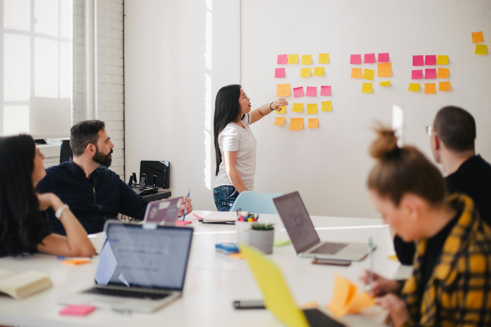 A cross-functional team mapping workflows and decisions together at a strategy wall